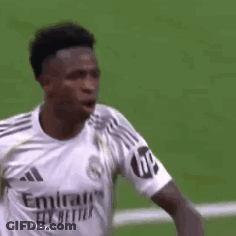 A Soccer Player Wearing A White Emirates Fly Better Jersey Is Standing On A Field . GIF