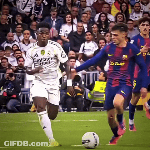 A Soccer Player Wearing A White Emirates Jersey Is Dribbling A Ball GIF