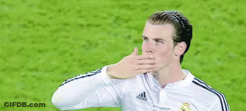 A Soccer Player Wearing A White Fly Emirates Jersey Is Waving His Hand . GIF