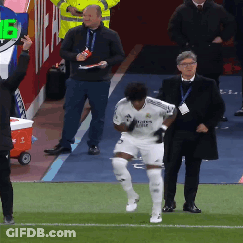 A Soccer Player Wearing A White Jersey That Says ' Emirates Fly Better ' GIF
