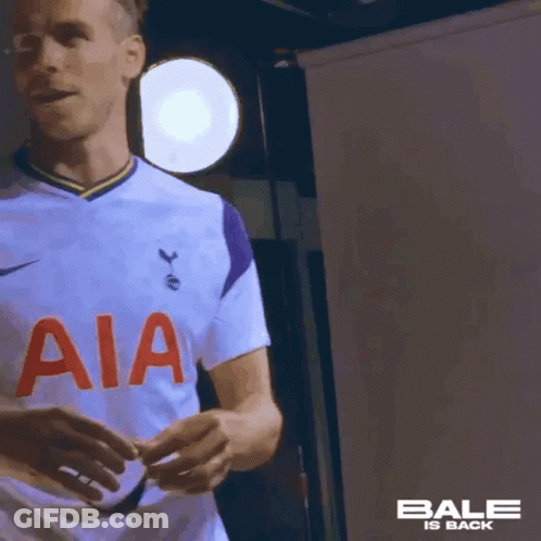 A Soccer Player Wearing A White Jersey With Aia On The Front Is Standing In Front Of A Light . GIF