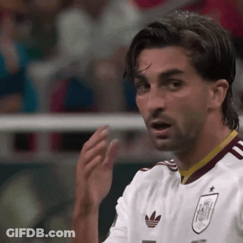A Soccer Player Wearing A White Jersey With An Adidas Logo GIF