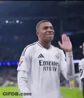 A Soccer Player Wearing A White Jersey With Emirates Fly Better On It Is Waving His Hand . GIF