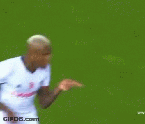 A Soccer Player Wearing A White Jersey With The Word Vodafone On It Is Running On The Field . GIF