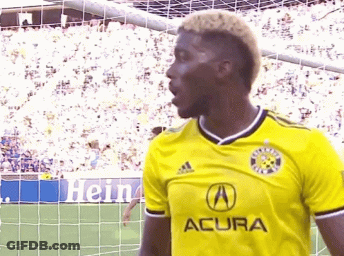 A Soccer Player Wearing A Yellow Acura Jersey GIF