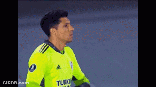 A Soccer Player Wearing A Yellow Adidas Jersey Is Standing On The Field . GIF