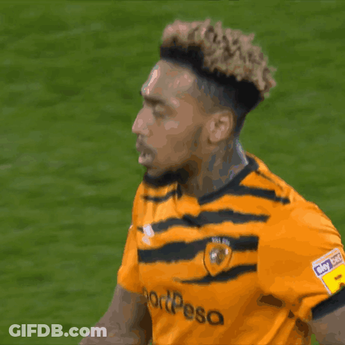 A Soccer Player Wearing A Yellow And Black Jersey That Says Sportpesa GIF