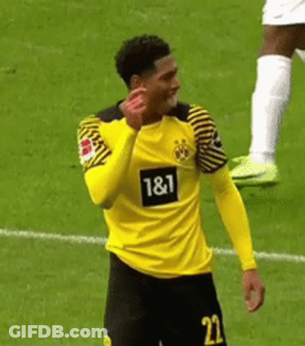 A Soccer Player Wearing A Yellow And Black Jersey With The Number 22 On It Is Standing On A Field . GIF