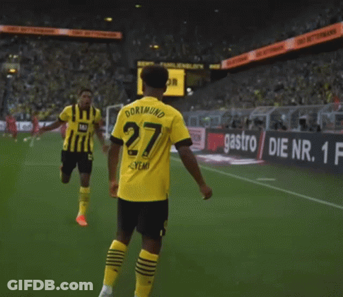 A Soccer Player Wearing A Yellow And Black Jersey With The Number 27 On It GIF