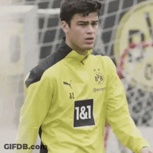 A Soccer Player Wearing A Yellow And Black Jersey With The Number 32 On It GIF