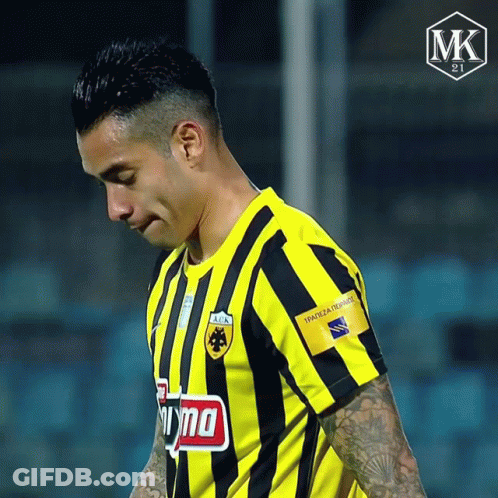 A Soccer Player Wearing A Yellow And Black Striped Shirt Has A Tattoo On His Arm That Says Mk On It GIF