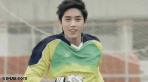 A Soccer Player Wearing A Yellow And Green Jersey With A X On It GIF