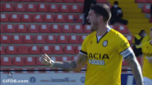 A Soccer Player Wearing A Yellow Dacia Jersey GIF