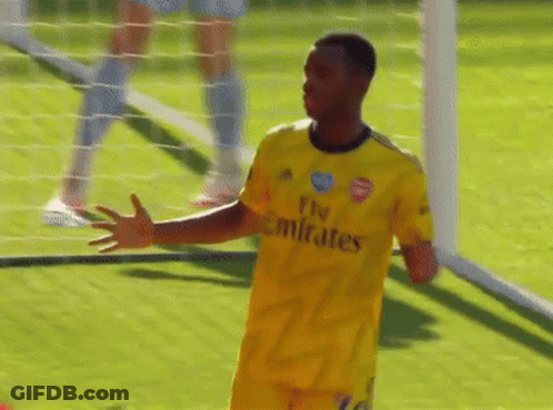 A Soccer Player Wearing A Yellow Fly Emirates Jersey Stands On The Field GIF