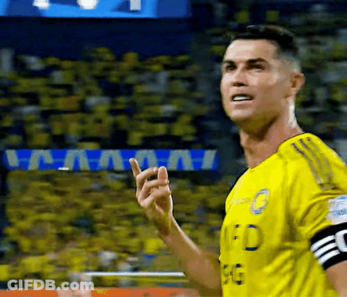 A Soccer Player Wearing A Yellow Jersey Is Giving A Thumbs Up GIF