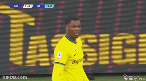 A Soccer Player Wearing A Yellow Jersey Is Walking On A Field . GIF