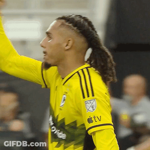 A Soccer Player Wearing A Yellow Jersey That Says Apple TV On The Sleeve GIF