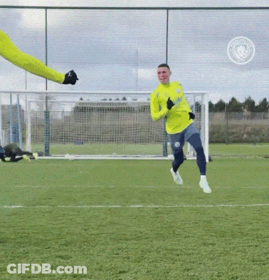 A Soccer Player Wearing A Yellow Jersey That Says Manchester City On It GIF
