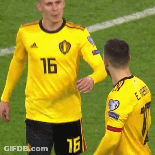 A Soccer Player Wearing A Yellow Jersey With The Number 16 On It Talks To Another Player GIF