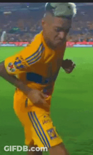 A Soccer Player Wearing A Yellow Jersey With The Number 18 On The Back GIF