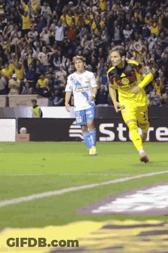 A Soccer Player Wearing A Yellow Jersey With The Number 2 On It Is Running On The Field GIF