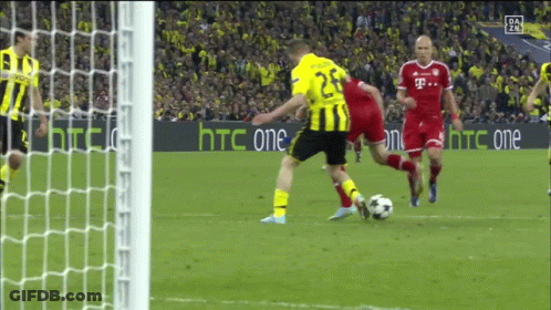 A Soccer Player Wearing A Yellow Jersey With The Number 25 Kicks The Ball GIF