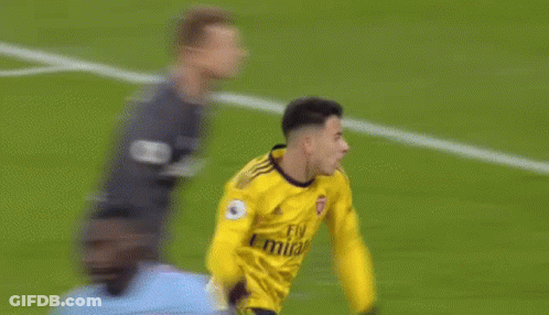 A Soccer Player Wearing A Yellow Jersey With The Number 3 On It Is Kicking The Ball . GIF