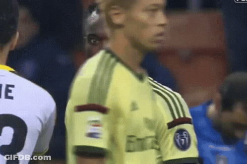 A Soccer Player Wearing A Yellow Jersey With The Word Emirates On It GIF