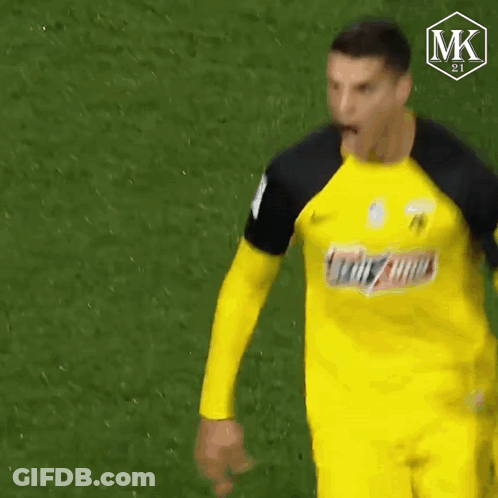 A Soccer Player Wearing A Yellow Jersey With The Word Mk On The Bottom GIF