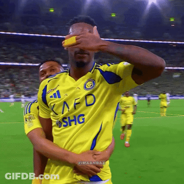 A Soccer Player Wearing A Yellow Kafd Shg Jersey Covers His Eyes GIF