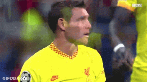 A Soccer Player Wearing A Yellow Nike Shirt Looks At The Camera GIF