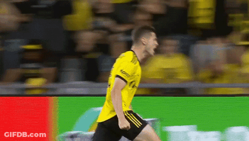 A Soccer Player Wearing A Yellow Shirt And Black Shorts GIF
