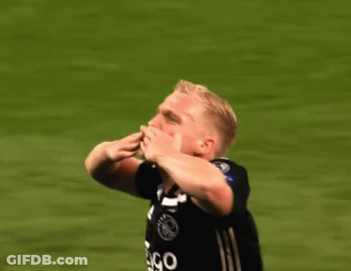 A Soccer Player Wearing A Ziggo Jersey Is Raising His Hands In The Air GIF
