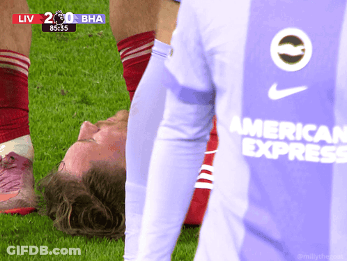 A Soccer Player Wearing An American Express Jersey Is Laying On The Field GIF
