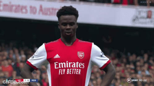 A Soccer Player Wearing An Emirates Fly Better Jersey Stands On The Field GIF