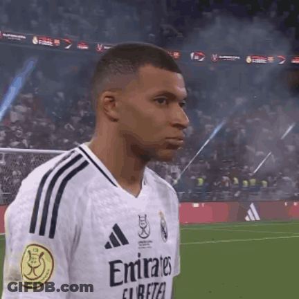 A Soccer Player Wearing An Emirates Jersey Is Standing On The Field GIF
