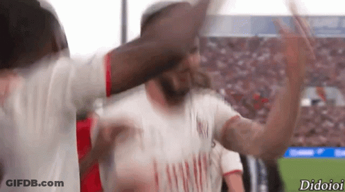 A Soccer Player Wearing An Emirates Shirt Is Celebrating With His Team GIF