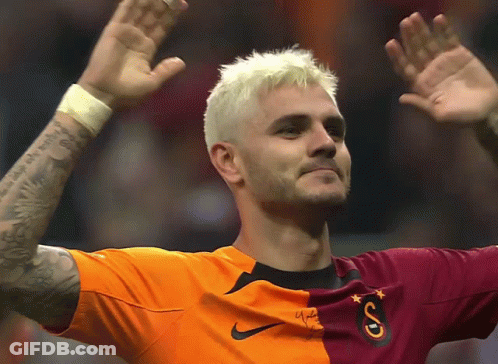 A Soccer Player Wearing An Orange And Maroon Shirt With The Letter S On It GIF