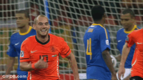 A Soccer Player Wearing An Orange Jersey With The Number 13 GIF