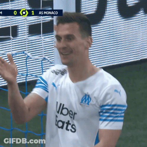 A Soccer Player Wearing An Uber Eats Shirt Waves His Hand GIF