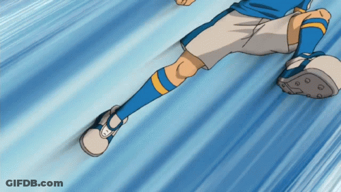 A Soccer Player Wearing Blue Socks And White Shorts Is Kicking A Ball GIF