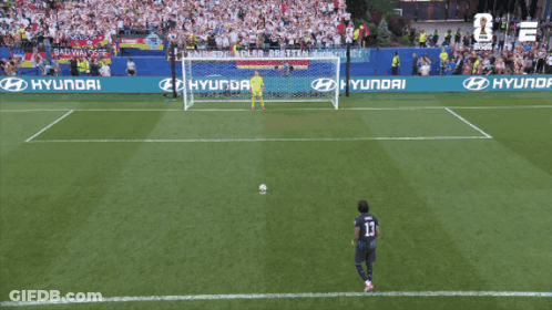 A Soccer Player Wearing Number 13 Kicks The Ball Into The Goal GIF
