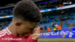 A Soccer Player Wipes His Eyes With His Hand In Front Of A Banner That Says ' Tiger ' On It GIF