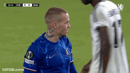 A Soccer Player With A Tattoo On His Neck Talks To Another Player On The Field GIF