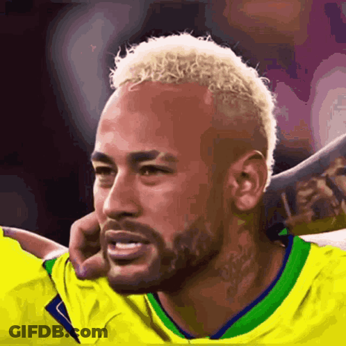 A Soccer Player With Blonde Hair And A Beard Is Wearing A Yellow Shirt . GIF