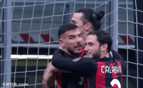 A Soccer Player With The Name Calabria On His Back Is Hugging Another Player GIF