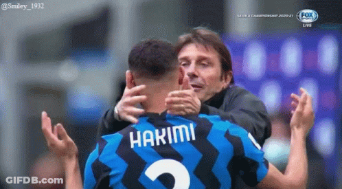 A Soccer Player With The Name Hakimi On His Jersey Is Hugging His Coach GIF