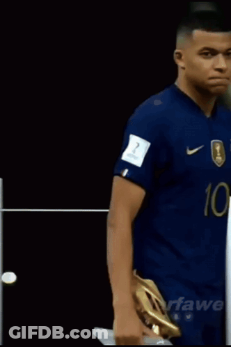 A Soccer Player With The Number 10 On His Jersey Is Holding A Golden Boot GIF