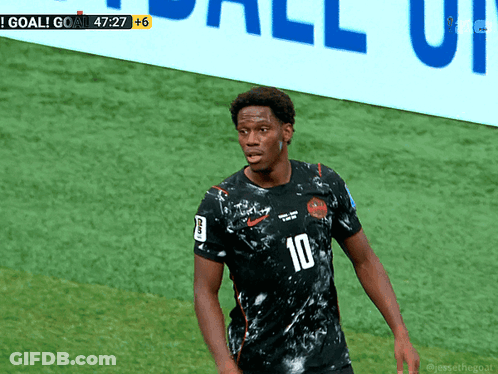 A Soccer Player With The Number 10 On His Jersey Stands On The Field GIF