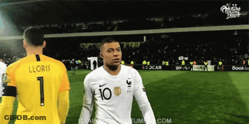 A Soccer Player With The Number 10 On His Shirt Is Standing Next To A Goalie . GIF